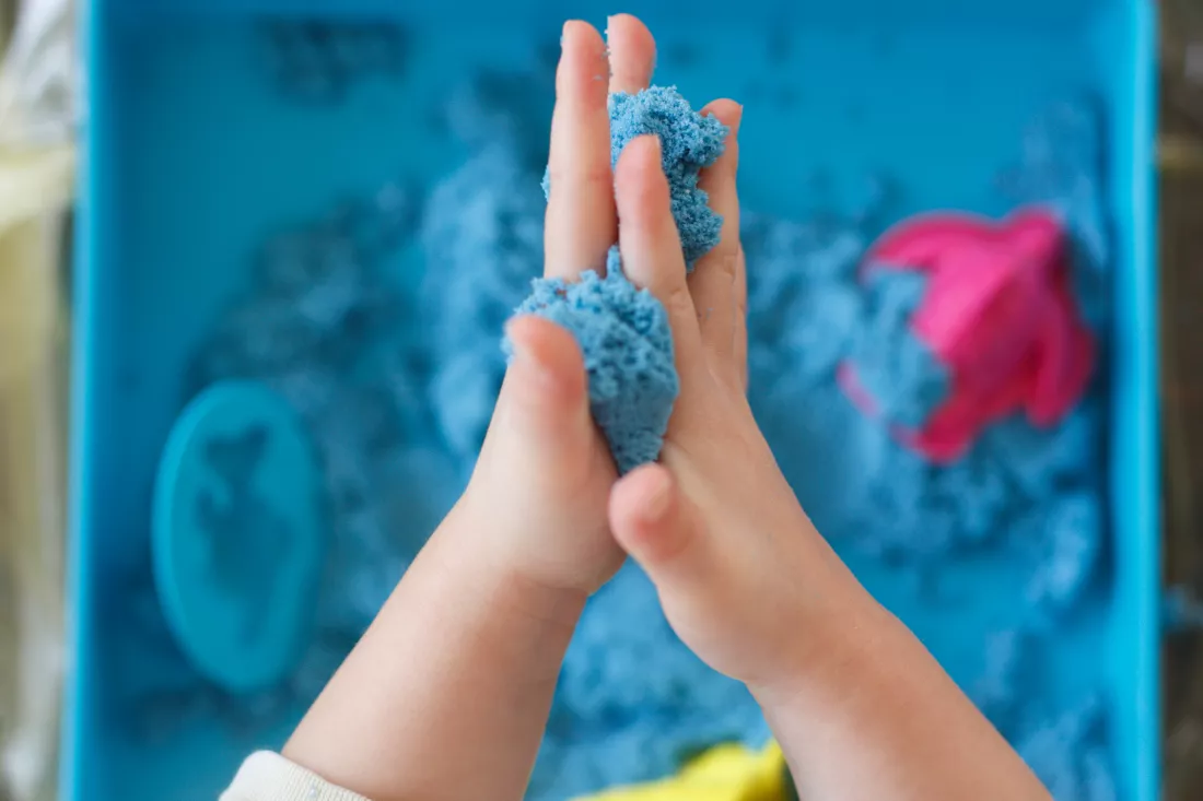close-up-child-holding-putty