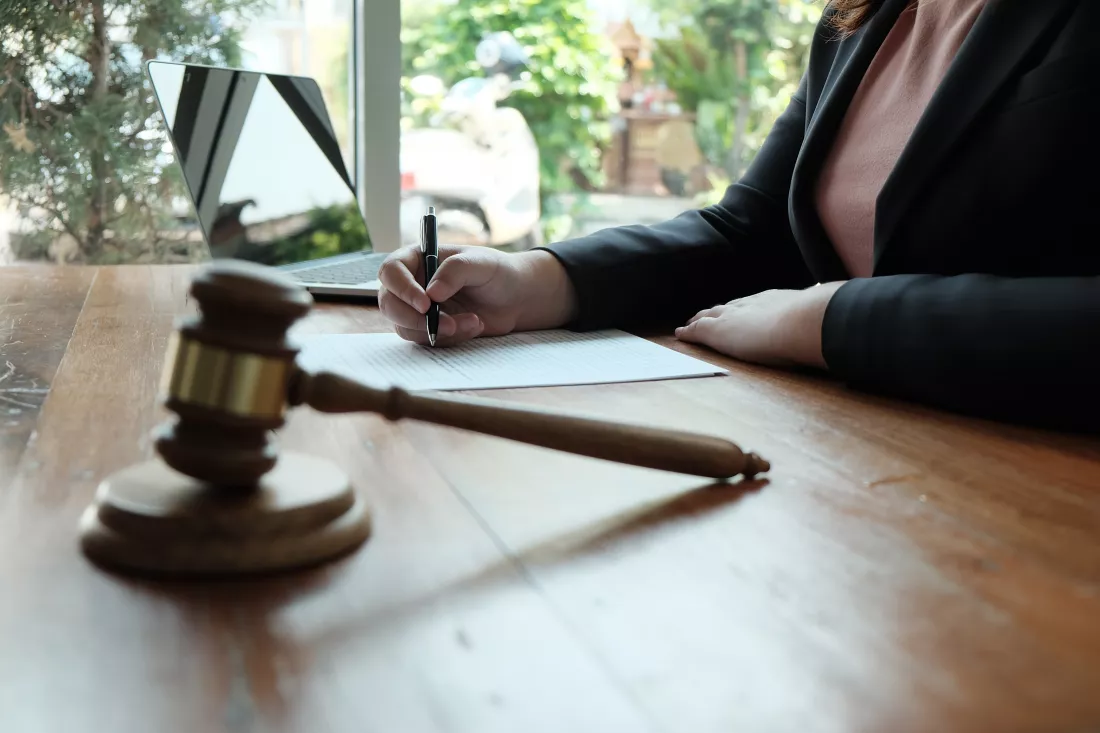 midsection-female-lawyer-writing-paper-office