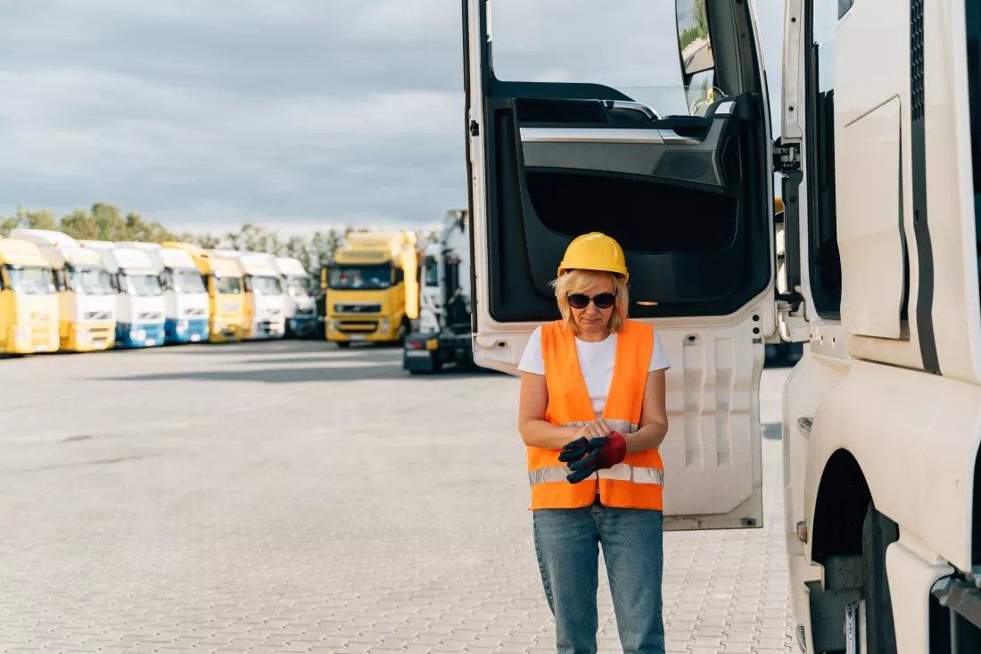 female-trucker-standing-by-truck