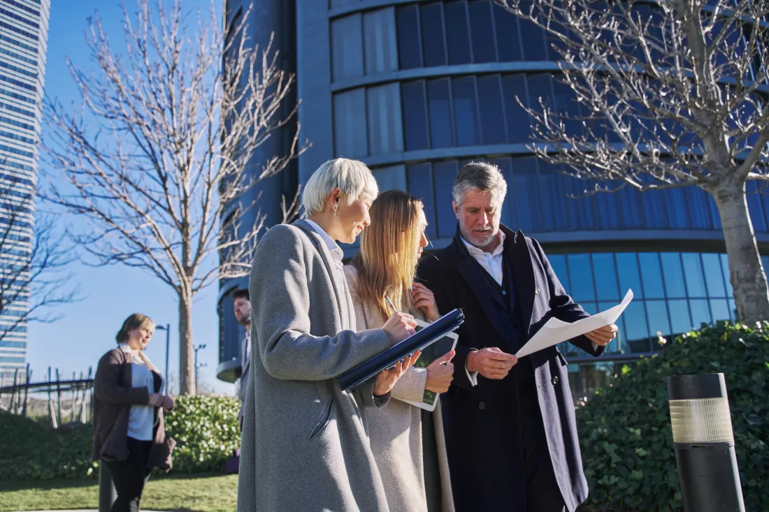 three-businessmen-outside-office-building-with-documents-discussing-plans-businessman-businesswomen-having-fun-chatting-talking-diverse-business-group-business-suits